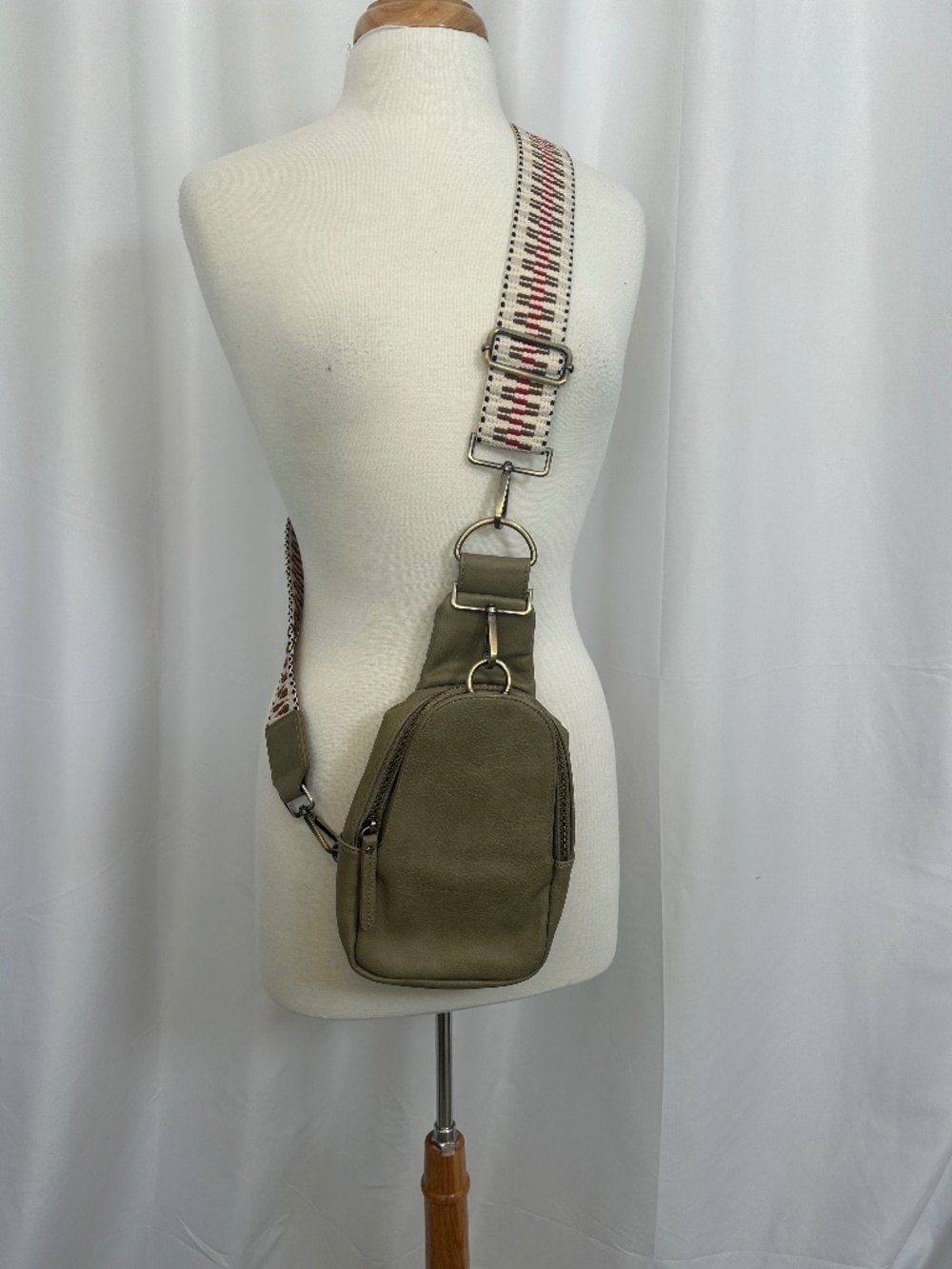 URBAN ORIGINALS ANTHROPOLOGIE LIBERTY SLING BAG IN TAUPE